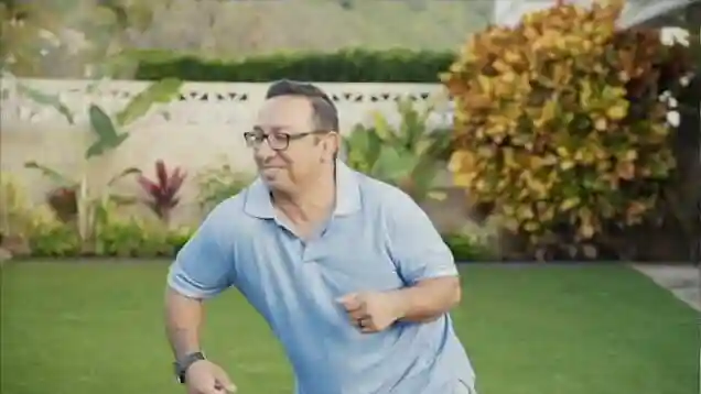 Image of a happy man dancing on his new SYNLawn artificial grass