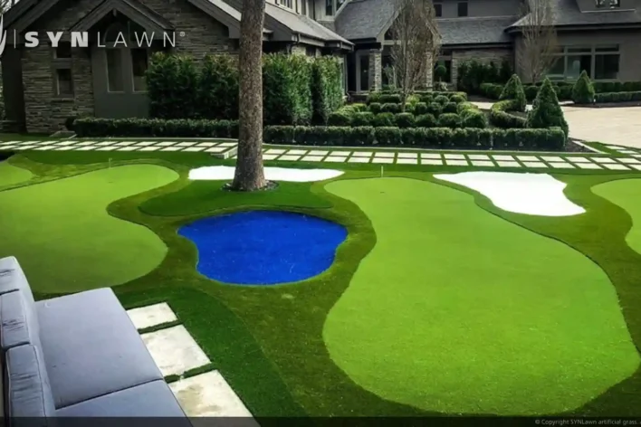 image of SYNLawn artificial grass putting greens in an outdoor backyard with pavers and water hazard